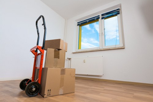 Movers carrying household items through a residential property