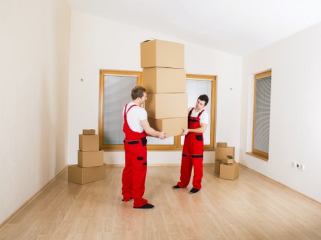 Commercial moving team handling office furniture and boxes